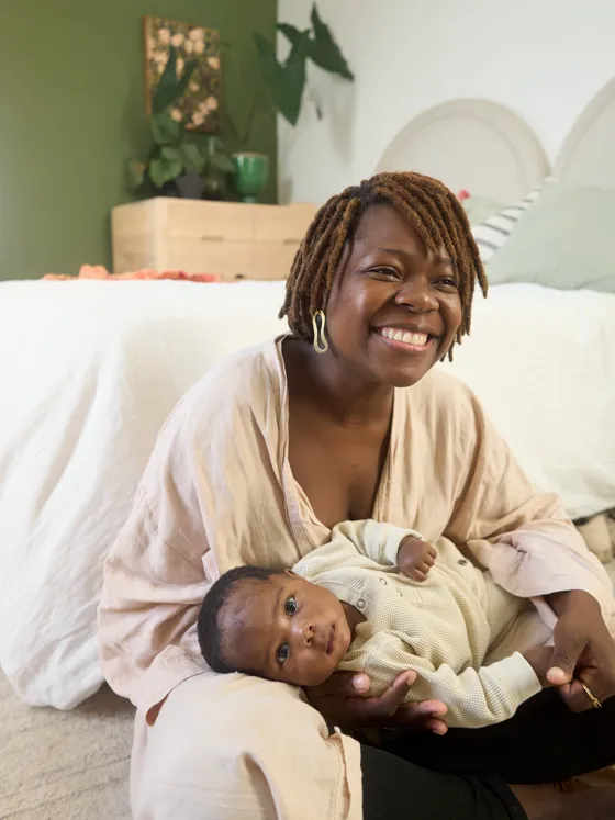 A smiling mother holding her newborn